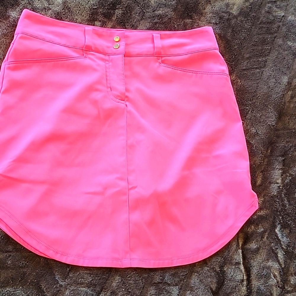 Hot pink golf skirt, 2 front pockets, one back pocket, curved bottom, snap/zippe